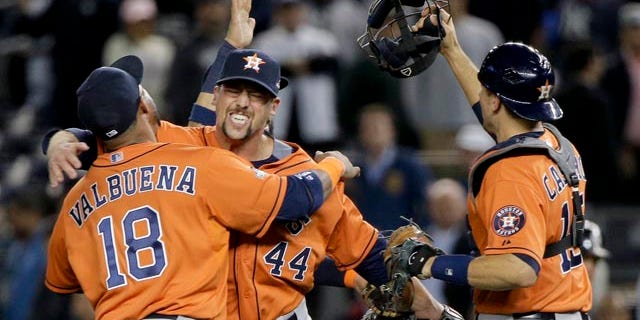 Oct. 6, 2015: Houston Astros' Luis Valbuena (18), Luke Gregerson (44) and Jason Castro, right, celebrate after the Astros defeated the New York Yankees 3-0 in the American League wild card baseball game in New York. (AP Photo/Julie Jacobson)