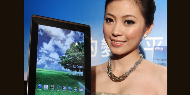 March 25, 2011: A Taiwanese model displays an Asus Eee Pad Transformer during its new product media event in Taipei, Taiwan. The Asus Eee Pad Transformer features a 10.1-inch touch screen, tablet with a detachable keyboard dock.