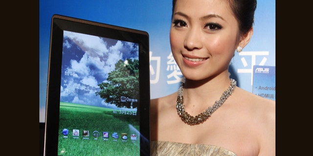 March 25, 2011: A Taiwanese model displays an Asus Eee Pad Transformer during its new product media event in Taipei, Taiwan. The Asus Eee Pad Transformer features a 10.1-inch touch screen, tablet with a detachable keyboard dock.