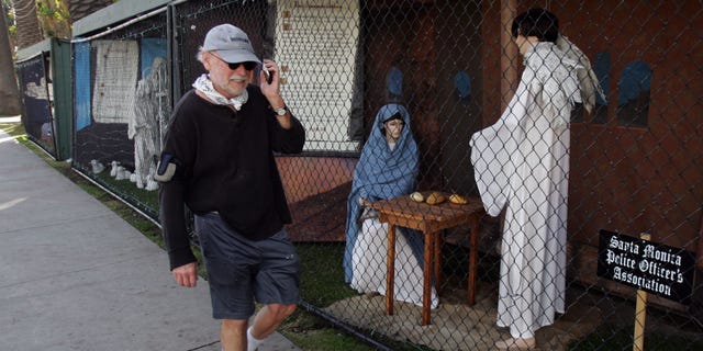 December 13: A man walks past a display showing the nativity scene along Ocean Avenue at Palisades Park in Santa Monica, California.