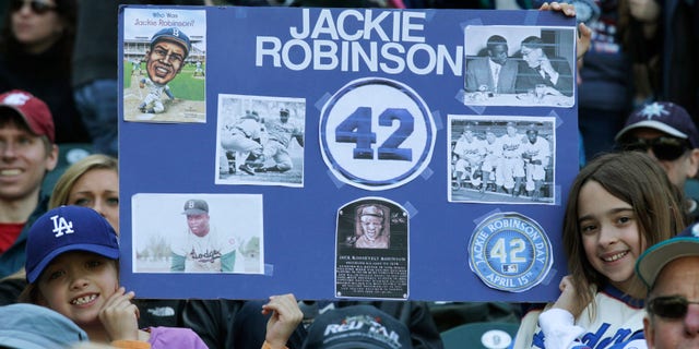 April 15: Young fans pay tribute to Jackie Robinson prior to a MLB baseball game between the Seattle Mariners and the Oakland Athletics in Seattle.