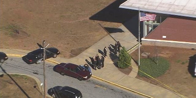 Jan. 31, 2013: In this image made from video and released by WSB-TV, authorities investigate the scene of a school shooting in Atlanta.
