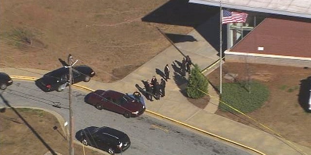 Jan. 31, 2013: In this image made from video and released by WSB-TV, authorities investigate the scene of a school shooting in Atlanta.