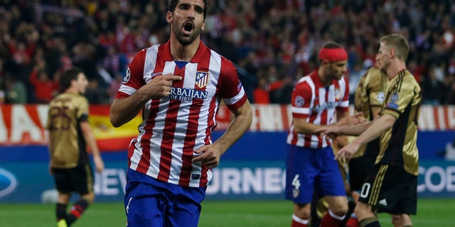 Atletico's Raul Garcia, centre, celebrates his goal during a Champions League last 16 second leg soccer match between Atletico Madrid and AC Milan, at the Vicente Calderon stadium in Madrid, Tuesday, March 11, 2014. (AP Photo/Andres Kudacki)