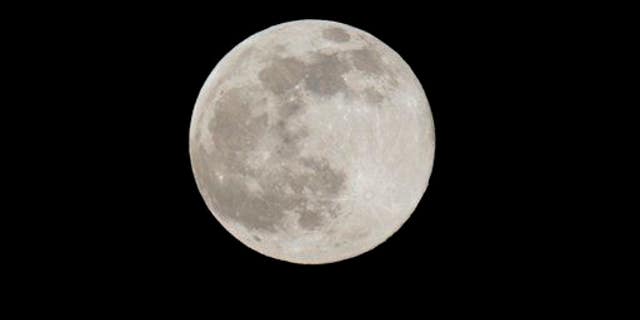 A Blue Moon rises Friday, July 31, 2015 as seen from Taguig city east of Manila, Philippines.