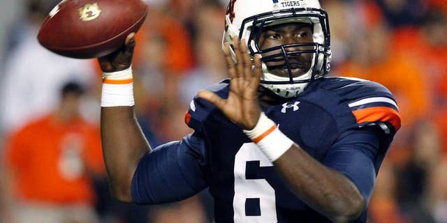 FILE - In this Oct. 26, 2013, file photo, Auburn quarterback Jeremy Johnson rolls out to pass during the first half of an NCAA college football game against Florida Atlantic in Auburn, Ala. Johnson says he has no idea if he's starting against Arkansas with starter Nick Marshall being held out for at least the opening. He does have one prediction: Marshall will win the Heisman Trophy. (AP Photo/Butch Dill, File)