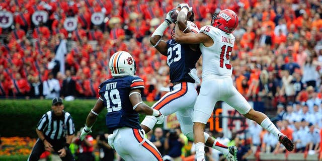 Sep 12, 2015; Auburn, AL, USA; Auburn Tigers defensive back Johnathan Ford (23) intercepts a Jacksonville State Gamecocks pass in the end zone intended for Jacksonville State Gamecocks wide receiver Ruben Gonzalez (15) during the third quarter at Jordan Hare Stadium. Mandatory Credit: Shanna Lockwood-USA TODAY Sports