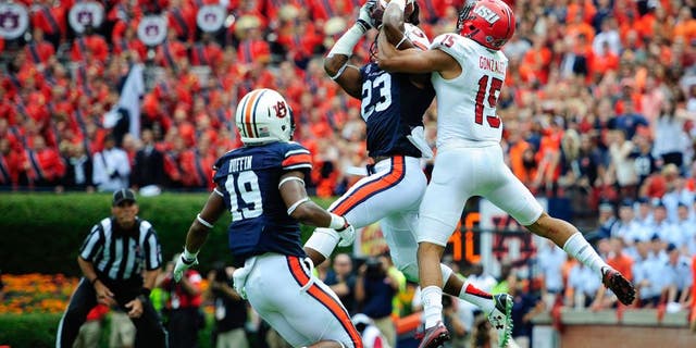 Sep 12, 2015; Auburn, AL, USA; Auburn Tigers defensive back Johnathan Ford (23) intercepts a Jacksonville State Gamecocks pass in the end zone intended for Jacksonville State Gamecocks wide receiver Ruben Gonzalez (15) during the third quarter at Jordan Hare Stadium. Mandatory Credit: Shanna Lockwood-USA TODAY Sports