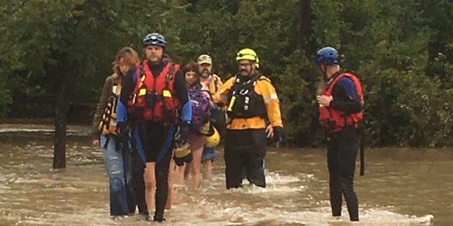 At least 60 people from a wedding party had to be rescued Saturday by rising floodwaters in Texas.