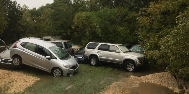 The fast-moving floodwaters were so strong, vehicles were swept away and ended up piled up.