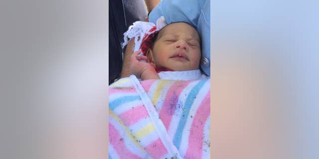 This photo released by New South Wales Police shows a newborn baby who was found Sunday, Nov. 23, 2014 abandoned in a drain in the Sydney suburb of Quakers Hill, Australia. Police are questioning a 20-year-old woman whose newborn baby was found abandoned in a drain next to a busy freeway by a group of cyclists. The baby, who is only a few days old, was in a serious but stable condition in Sydney's Westmead Children's Hospital, police said in a statement.(AP Photo/NSW Police)