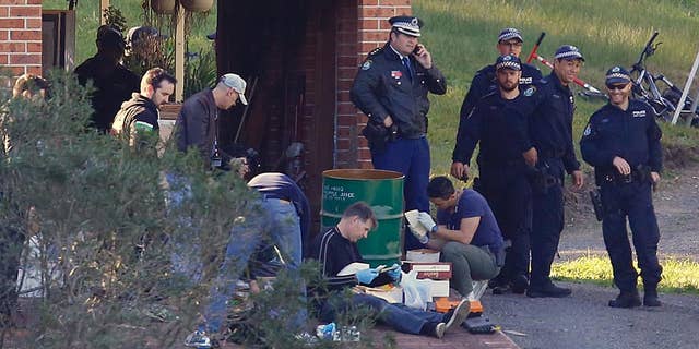 Police search the property and family home of Leonard John Warwick in Douglas Park, near Sydney, Australia, Wednesday, July 29, 2015. More than 30 years after series of bombings and shootings left four people dead and terrorized the Australian legal fraternity police have arrested Warwick, a 68-year-old suspect. (David Moir/AAP Image via AP) NO ARCHIVING, AUSTRALIA OUT, NEW ZEALAND OUT, PAPUA NEW GUINEA OUT, SOUTH PACIFIC OUT, NO SALES