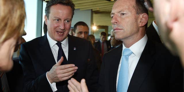 Nov. 14, 2014: British Prime Minister David Cameron, left, gestures as he stands with Australian Prime Minister Tony Abbott as the speak with guests at an infrastructure business breakfast in Sydney, Australia