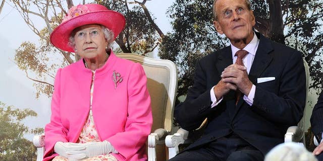 FILE - In this Oct. 26, 2011 file photo, Britain's Queen Elizabeth II, left, and her husband Prince Philip attend the opening of the new Royal Children's Hospital in Melbourne, Australia. Australia's prime minister on Monday, Jan. 26, 2015 dismissed criticism of his decision to the Duke of Edinburgh an Australian knight, saying Philip has a long history of service Down Under. Prime Minister Tony Abbott's announcement that the duke would be awarded Australia's highest honor came on Australia's national holiday, prompting some to question the wisdom of knighting a British royal on a day meant to commemorate Australians. (AP Photo/Andrew Brownbill, File)