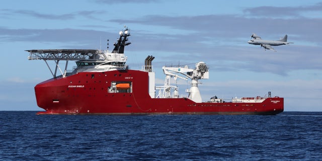 In this April 9, 2014 photo provided by the Australian Defense Force, a Royal Australian Air Force AP-3C Orion flies past Australian Defense vessel Ocean Shield on a mission to drop sonar buoys to assist in the acoustic search of the missing Malaysia Airlines Flight 370 in the southern Indian Ocean. The ship searching for the missing Malaysian jet has detected two more underwater signals that may be emanating from the aircraft's black boxes, and the Australian official in charge of the search expressed hope Wednesday that the plane's wreckage will soon be found. (AP Photo/Australian Defense Force, LSIS Bradley Darvill) EDITORIAL USE ONLY