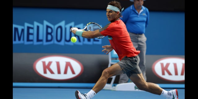 Nadal reaches for a ball to Nishikori during their fourth round match at the Australian Open in Melbourne, Australia, Jan. 20, 2014.