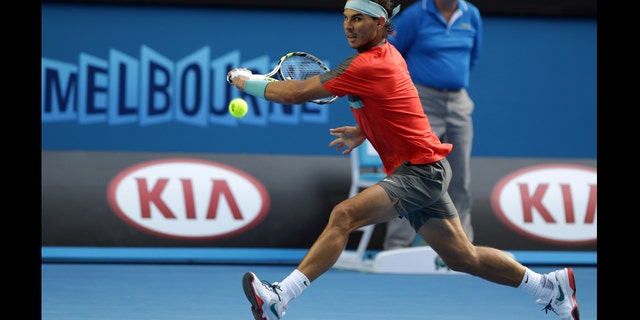 Nadal reaches for a ball to Nishikori during their fourth round match at the Australian Open in Melbourne, Australia, Jan. 20, 2014.