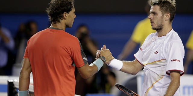 January 26, 2014: Stanislas Wawrinka of Switzerland, right, shakes hands with Rafael Nadal of Spain at the net after Wawrinka won the men's singles final at the Australian Open tennis championship in Melbourne.(AP Photo/Rick Rycroft)