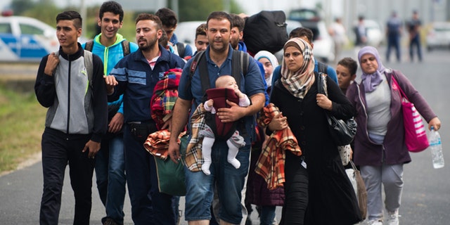 Sept. 14, 2015: Refugees arrive at the border between Austria and Hungary near Heiligenkreuz.