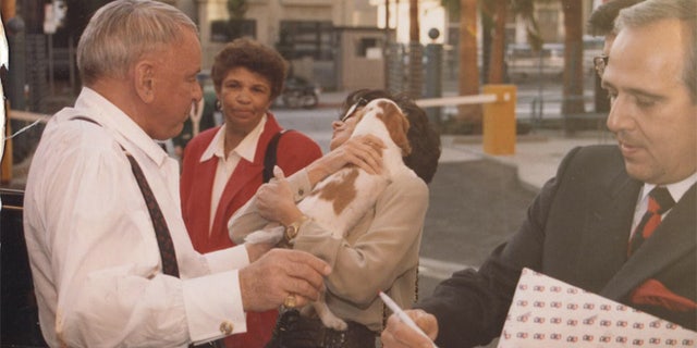 Frank Sinatra greeting a fan.