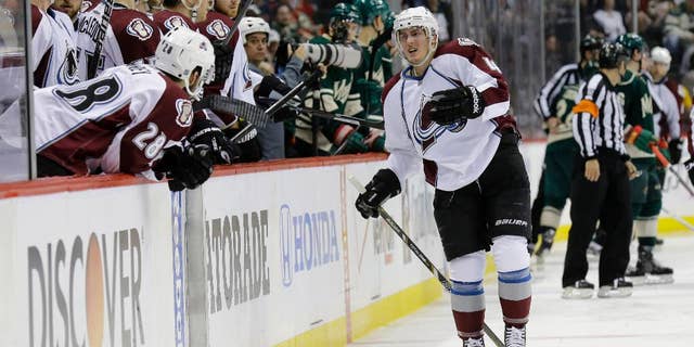 Colorado Avalanche defenseman Tyson Barrie, right, leaves the ice after getting injured on a hit by Minnesota Wild left wing Matt Cooke during the second period of Game 3 of an NHL hockey first-round playoff series in St. Paul, Minn., Monday, April 21, 2014. The Wild won 1-0 in overtime. (AP Photo/Ann Heisenfelt)