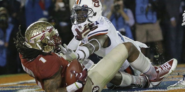Florida State's Kelvin Benjamin catches a touchdown pass in front of Auburn's Chris Davis during the second half of the NCAA BCS National Championship college football game Monday, Jan. 6, 2014, in Pasadena, Calif. (AP Photo/David J. Phillip)