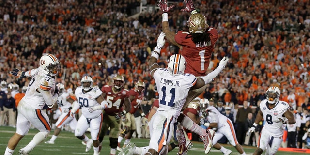 Florida State's Kelvin Benjamin catches the game-winning touchdown pass during the second half of the NCAA BCS National Championship college football game against Auburn Monday, Jan. 6, 2014, in Pasadena, Calif. (AP Photo/Chris Carlson)