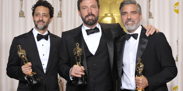 Grant Heslov, from left, Ben Affleck, and George Clooney pose with their award for best picture for "Argo" during the Oscars at the Dolby Theatre on Sunday Feb. 24, 2013, in Los Angeles.