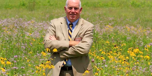 July 17, 2014: Terrence Slaybaugh, director of aviation for Dayton International Airport, poses in one of the airport's prairies in Vandalia, Ohio.