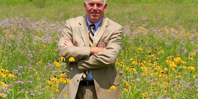 July 17, 2014: Terrence Slaybaugh, director of aviation for Dayton International Airport, poses in one of the airport's prairies in Vandalia, Ohio.