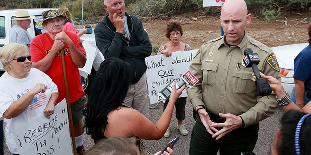 ORACLE, AZ JULY 15: Pinal County Head Sheriff Paul Babeu speaks with anti-immigration activists and the media during a protest along Mt. Lemmon Road in anticipation of buses carrying illegal immigrants on Jully 15, 2014 in Oracle, Arizona. About 300 protesters lined the road waiting for a busload of illegal immigrants who are to be housed at a facility in Oracle. (Photo by Sandy Huffaker/Getty Images)