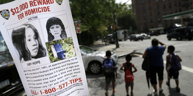 This Tuesday, July 23, 2013, photo shows a poster soliciting information regarding an unidentified body near the site where the body was found in New York. (AP Photo/Seth Wenig)