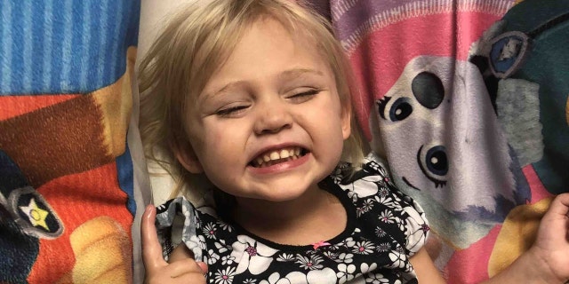 The 2-year-old undergoes physical therapy two times per day and is working to regain full use of her left hand.