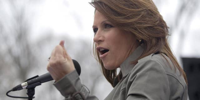 Rep. Michele Bachmann, R-Minn. gestures while addressing a Tea Party "Continuing Revolution Rally" on Capitol Hill in Washington, Thursday, March 31, 2011. (AP Photo/Evan Vucci)