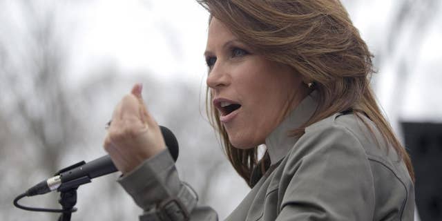 Rep. Michele Bachmann, R-Minn. gestures while addressing a Tea Party "Continuing Revolution Rally" on Capitol Hill in Washington, Thursday, March 31, 2011. (AP Photo/Evan Vucci)