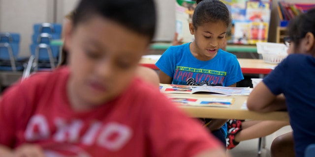 This photo taken July 21, 2014 shows students in Jane Cornell's summer school class learn story telling skills at Mary D. Lang Kindergarten Center in Kennett Square, Pa. For the first time ever _ U.S. public schools are projected this fall to have more minority students enrolled than white, a shift largely fueled by growth in the numbers of Hispanic children. White students are still expected to be the largest racial group in the public schools this year at 49.8 percent, but according to the National Center for Education Statistics, minority students, when added together, will now make up the majority. (AP Photo/Matt Rourke)