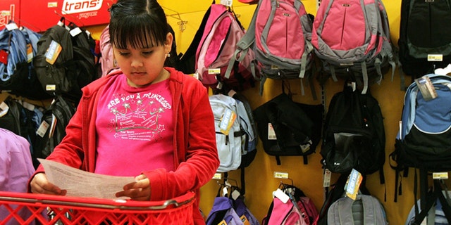 ROSEMONT, IL - AUGUST 11: Patricia Zaragoza, 9, checks her back-to-school shopping list at a Target store August 11, 2005 in Rosemont, Illinois. With the start of school nearing, retailers are stocking up in anticipation of back-to-school shoppers. (Photo by Tim Boyle/Getty Images)