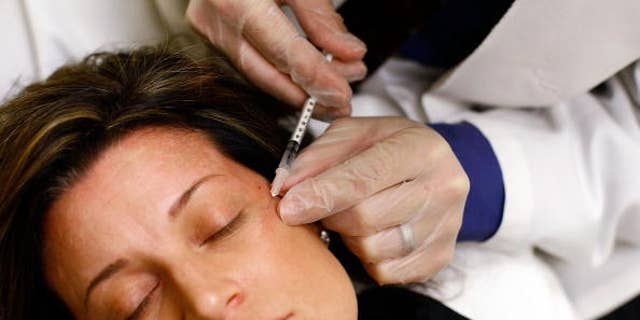  Woman receives a Botox injection during an event called the "The Botox Bailout." 