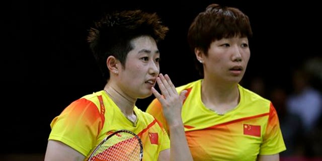 July 31, 2012: China's Yu Yang, left, and Wang Xiaoli talk while playing against Jung Kyun-eun and Kim Ha-na, of South Korea, in a women's doubles badminton match at the 2012 Summer Olympics.