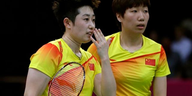 July 31, 2012: China's Yu Yang, left, and Wang Xiaoli talk while playing against Jung Kyun-eun and Kim Ha-na, of South Korea, in a women's doubles badminton match at the 2012 Summer Olympics.