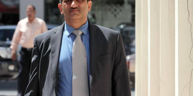 FILE - In this May 18, 2011, file photo, Mansour al-Jamri, former chief editor of the Bahraini opposition newspaper Al Wasat, arrives at the courthouse in Manama, Bahrain. The official Bahrain News Agency said in a brief statement issued Thursday, Aug. 6, 2015, that the suspension of the publication of the independent newspaper Al-Wasat. is "due to its violation of the law and repeated dissemination of information that affects national unity and the Kingdom's relationship with other countries." (AP Photo/Hasan Jamali, File)