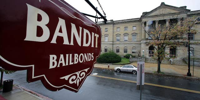 FILE-This Oct. 23, 2014 file photo a sign is seen outside a bail bondsman across the street from Mercer County criminal courthouse in Trenton, N.J. In courtrooms across the country every day, a price tag is put on freedom and for many it’s too expensive. With more than 60 percent of inmates in jails nationwide awaiting trial and many unable to afford bail, some states and counties are looking at overhauling the system so it’s based less on money and more on holding dangerous defendants. Earlier this year, New Jersey became the latest state to adopt a system that bases bail on a risk analysis of each defendant. (AP Photo/Mel Evans,File)