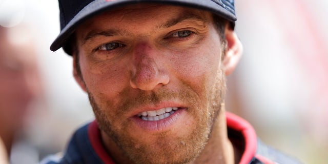 FILE - KTM rider Kurt Caselli of the U.S. talks to a KTM team member after the 14th stage of the Dakar Rally from La Serena to Santiago, Chile, in this Jan. 19, 2013 file photo. Caselli died Friday Nov. 15, 2013 after wrecking in the Baja 1000 in Mexico, event sanctioning body Score International said Saturday. the 30-year-old Caselli, from Palmdale, Calif., died of trauma after losing control of his KTM in a sandy, high-speed section while leading with about 100 miles left, according to Score (AP Photo/Victor R. Caivano, File)
