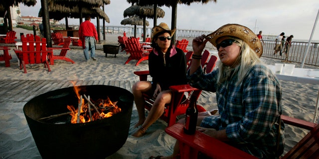 ROSARITO, MEXICO - APRIL 1: Carol Arthur (R) and Tammy Delu, from Seattle, sit at a bar along the beach April 1, 2009 in Rosarito, Mexico. (Photo by Sandy Huffaker/Getty Images)