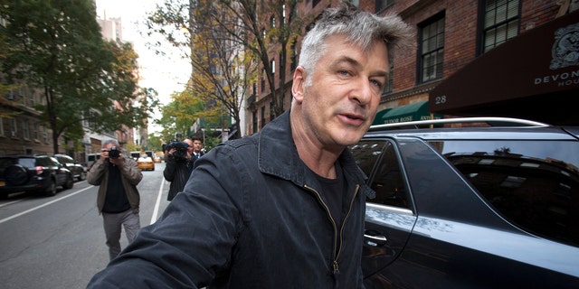 Actor Alec Baldwin shoves a photographer and tells him to move out of his way after he arrived in his SUV at the building where he lives in New York November 15, 2013. (REUTERS/Carlo Allegri)