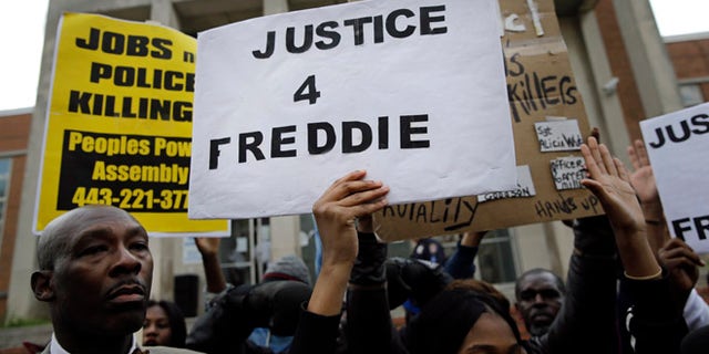 April 21: Protestors stand outside of the Baltimore Police Department's Western District police station during a march and vigil for Freddie Gray.