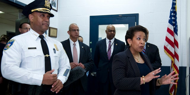 May 5, 2015: Attorney General Loretta Lynch, right, accompanied by Baltimore police Commissioner Anthony Batts, speaks to Baltimore police officers during a visit to the Central District of Baltimore Police Department. (AP Photo/Jose Luis Magana, Pool)