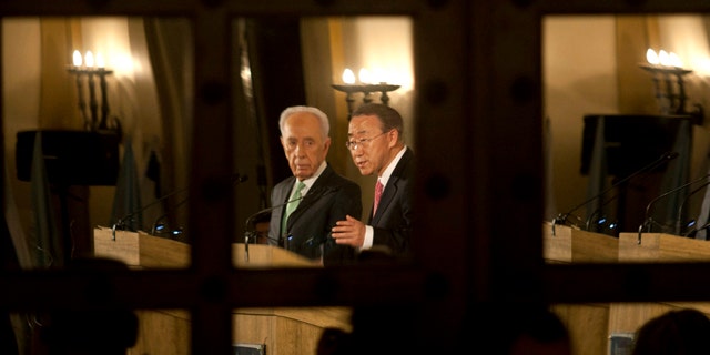Feb. 1: Israel's President Shimon Peres, left, and United Nations Secretary General Ban Ki-moon are seen reflected in a door's mirror as they speak at a Jerusalem hotel.
