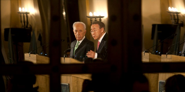 Feb. 1: Israel's President Shimon Peres, left, and United Nations Secretary General Ban Ki-moon are seen reflected in a door's mirror as they speak at a Jerusalem hotel.
