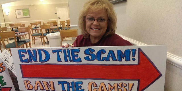 Kelly Canon, above, vice president of the Arlington Tea Party, spearheaded a petition drive along with friend Faith Bussey to ban red light cameras from the city.